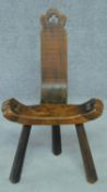 A 19th century pitch pine country spinning chair on three inverted chamfered tapering supports. H.