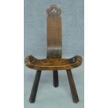 A 19th century pitch pine country spinning chair on three inverted chamfered tapering supports. H.