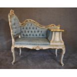 A cream and gilt Louis XV style hall seat with lavish Rococo carving in pale blue buttoned