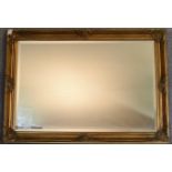 A gilt framed wall mirror with rectangular bevelled plate. 73cm x 100cm