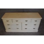 A cream lacquered Victorian style bank of eight drawers. H.70 x 140cm