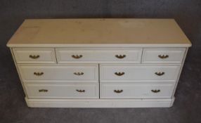 A cream lacquered Victorian style bank of eight drawers. H.70 x 140cm