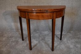 A Georgian mahogany and satinwood inlaid foldover top demi lune card table. H.74 x 92cm