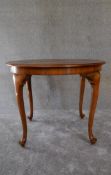 A Queen Anne style walnut occasional table on cabriole supports. H.69 x 90cm