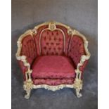 A cream and gilt Baroque style armchair in rouge buttoned damask upholstery. H.97 x 80cm