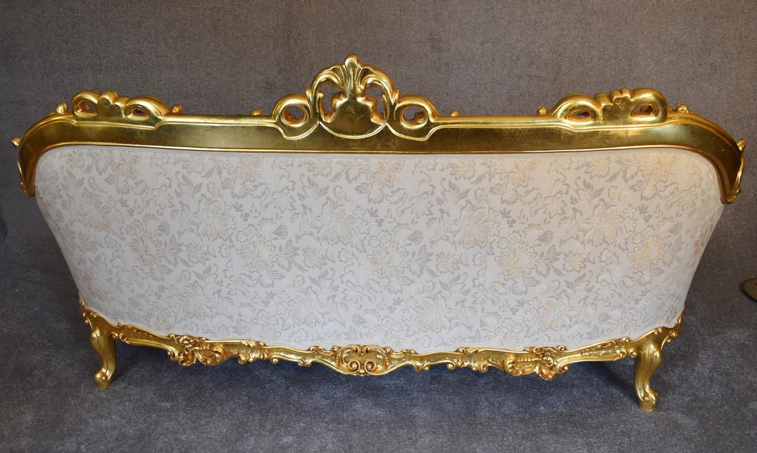 A heavily carved gilt framed Baroque style three cushion sofa with cream fabric and gold coloured - Image 5 of 5