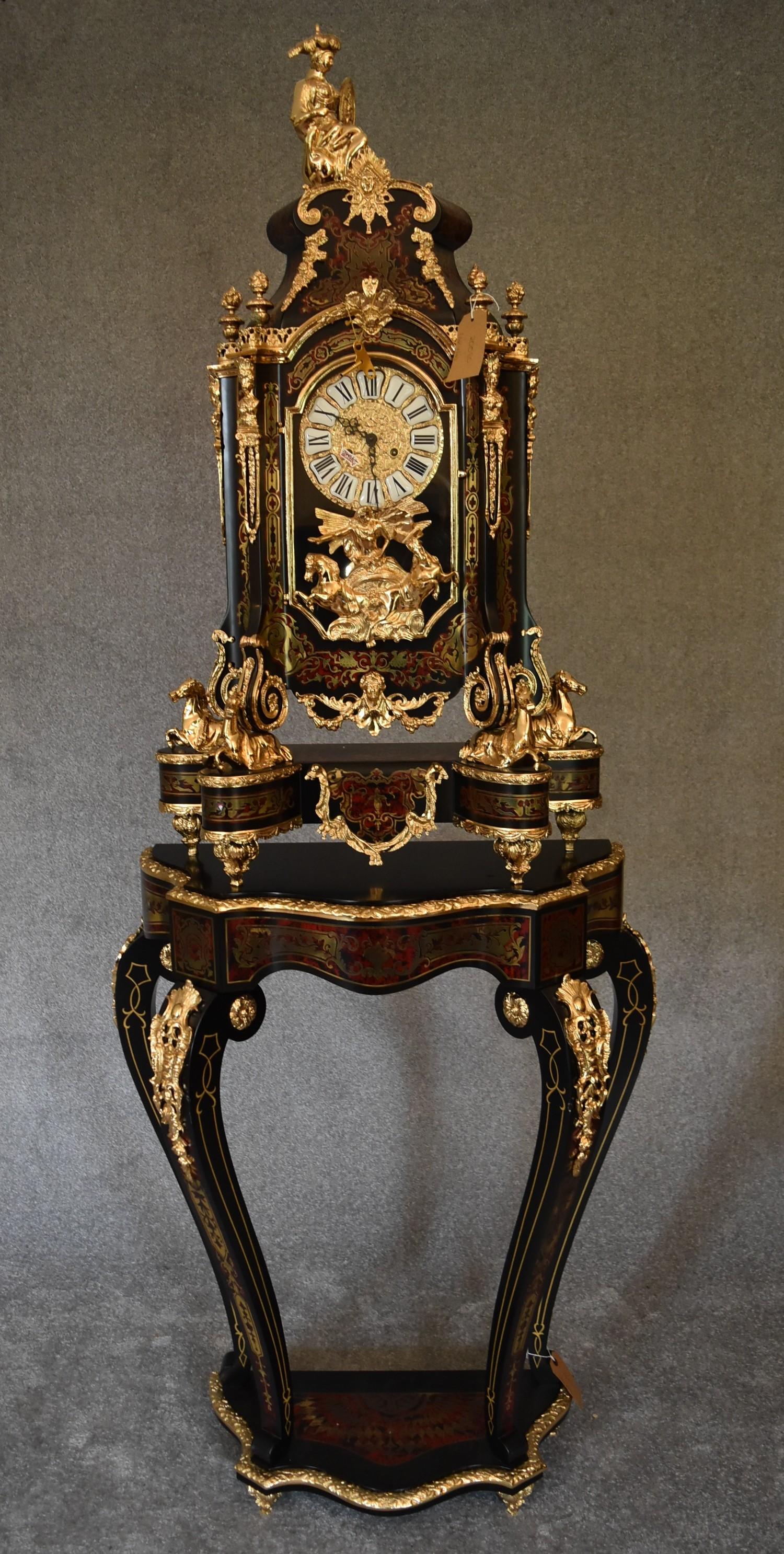 A decorative French style mantel clock in the Boulle manner with figural surmount on matching