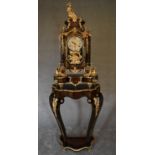 A decorative French style mantel clock in the Boulle manner with figural surmount on matching