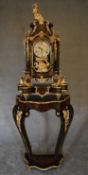 A decorative French style mantel clock in the Boulle manner with figural surmount on matching