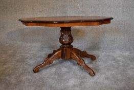 A burr walnut shaped top coffee table on carved quadruped supports. H.95cm x 60cm.