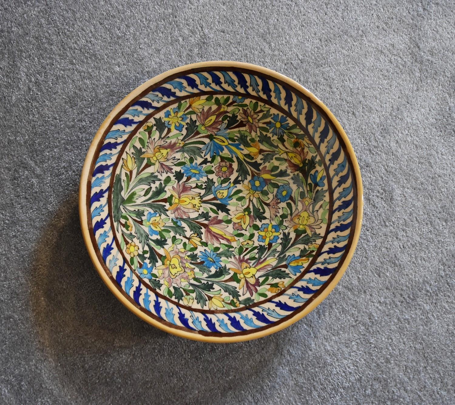 A large Persian ceramic shallow bowl with allover floral pattern. Dia.42cm