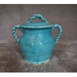 A Persian glazed ceramic blue pot with lid. H.20cm x W.18cm