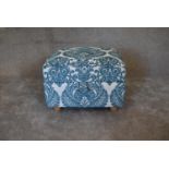 A pale blue patterned fabric footstool with lift up lid and storage compartment. H.45 x 62cm