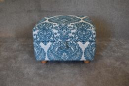 A pale blue patterned fabric footstool with lift up lid and storage compartment. H.45 x 62cm