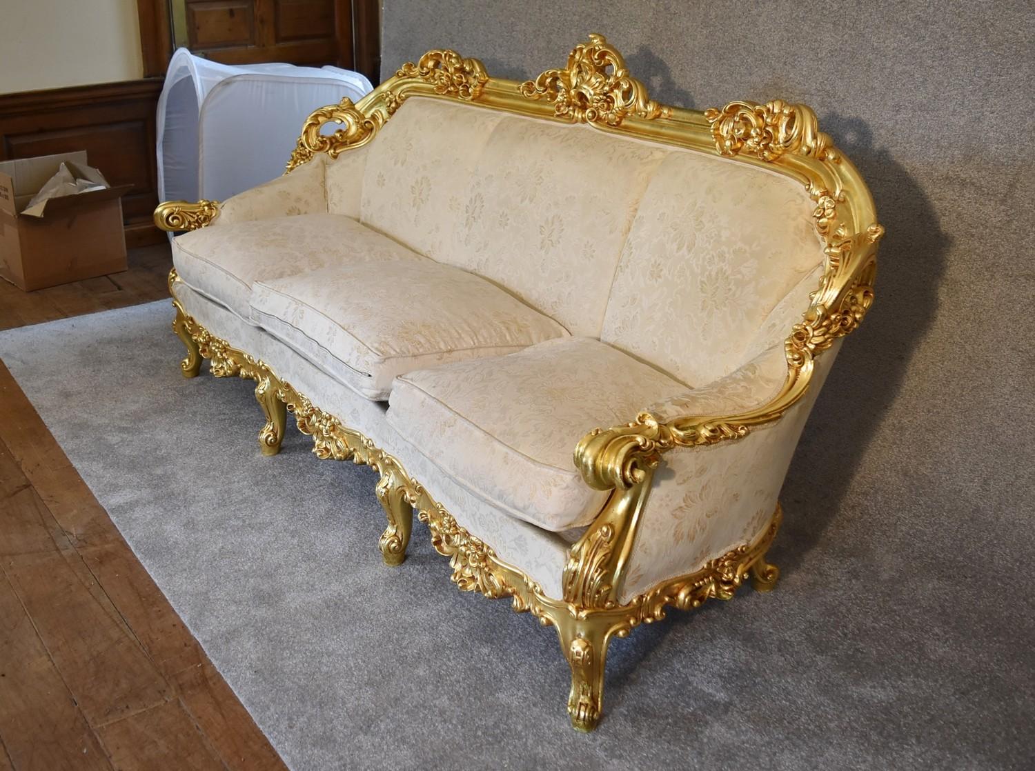 A heavily carved gilt framed Baroque style three cushion sofa with cream fabric and gold coloured - Image 3 of 5