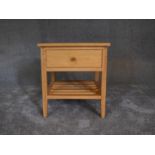 A small teak side table fitted frieze drawer and undertier. H.56 x 52cm