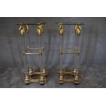 A pair of tall gilt metal glass and perspex torchere stands. 40cm x 90cm. (damage to one top).