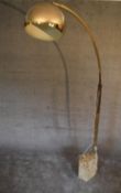 A large floor standing angle poise lamp with marble base and square section brass arm with large