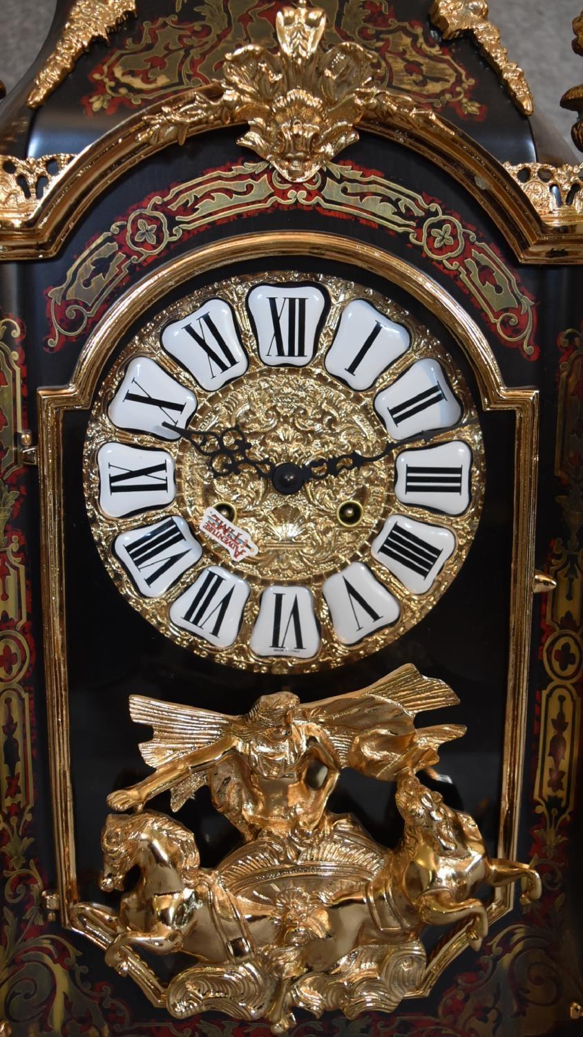 A decorative French style mantel clock in the Boulle manner with figural surmount on matching - Image 3 of 6