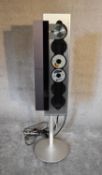 A Bang and Olufsen BeoSound 9000 vertical 6-CD player with floor stand. H 133 x 36cm