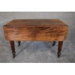 A Regency mahogany extending dining table with drop flaps on tapering reeded supports. H.79 x