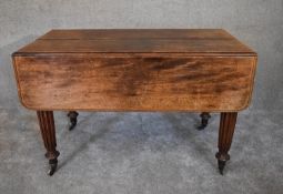 A Regency mahogany extending dining table with drop flaps on tapering reeded supports. H.79 x