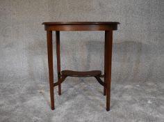 An Edwardian mahogany and inlaid shaped top occasional table. H.72 x 62cm