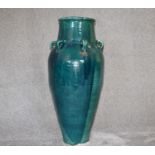 A large green drip glazed sharab wine vessel with six handles. H.94cm