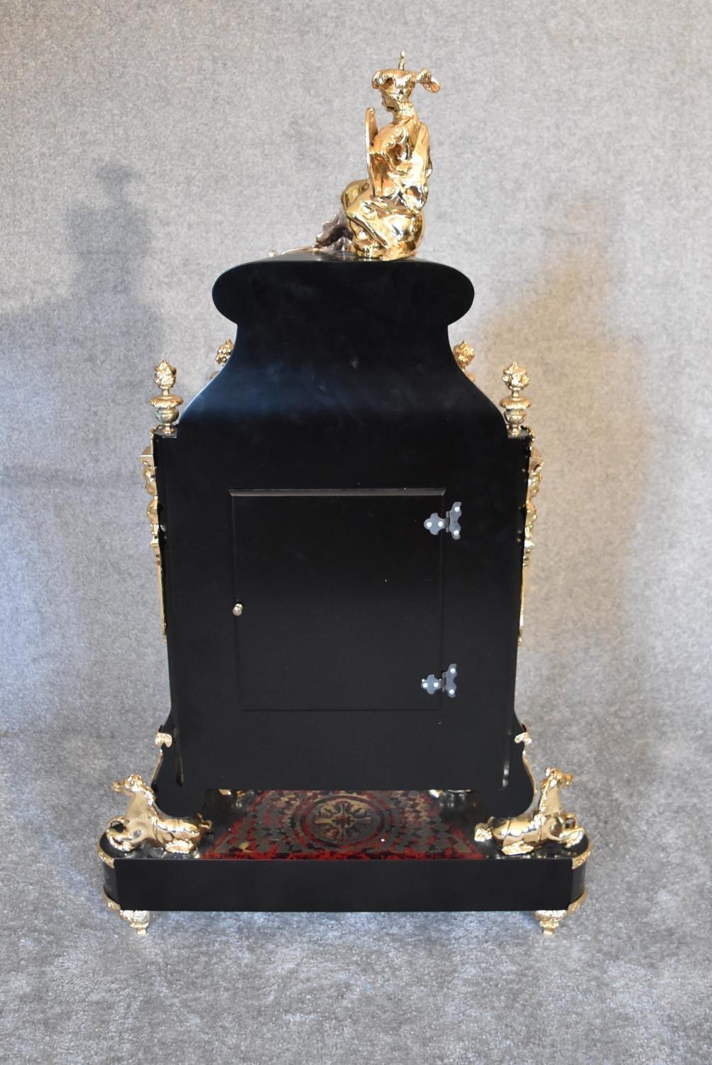 A decorative French style mantel clock in the Boulle manner with figural surmount on matching - Image 5 of 6