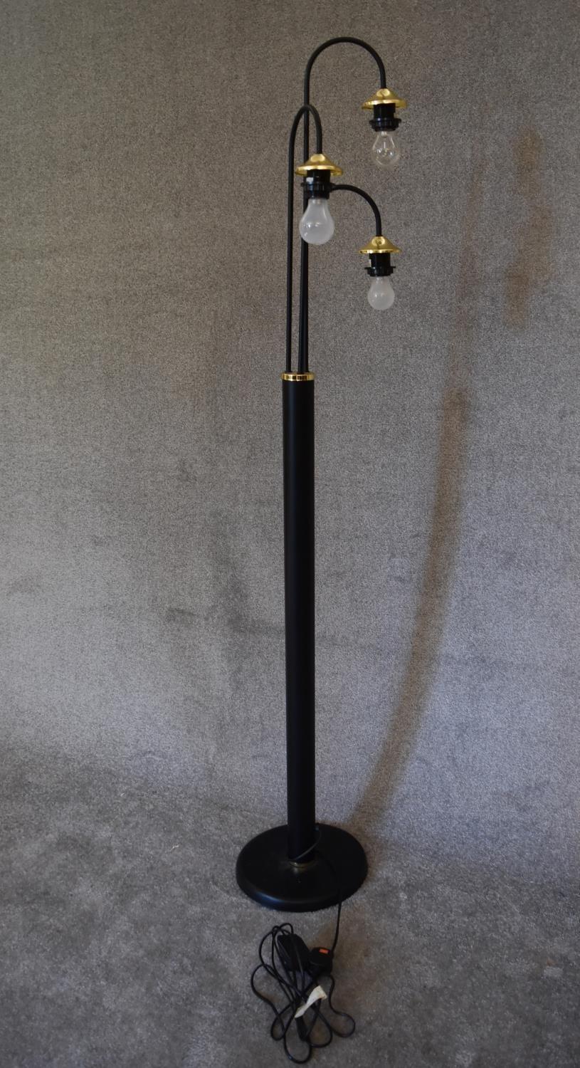 A floor standing lamp with black base and three branches each with brass light fittings, - Image 2 of 4