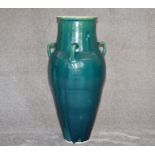 A large green drip glazed sharab wine vessel with four handles. H.87cm