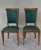 A pair of Empire style dining chairs upholstered in green fabric. H.97 x 45cm