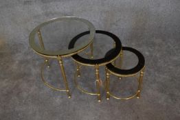 A nest of three brass circular graduating tables with clear glass tops and mirrored edges. Largest