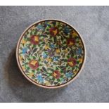 A large ceramic Persian shallow bowl with allover floral pattern. Dia.40cm