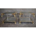 A pair of Empire style side tables with gilt metal frame and mirrored shelf to base and glass