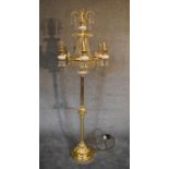 A gilt metal and crystal floor standing six branch chandelier. 1.8m tall.