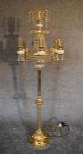 A gilt metal and crystal floor standing six branch chandelier. 1.8m tall.