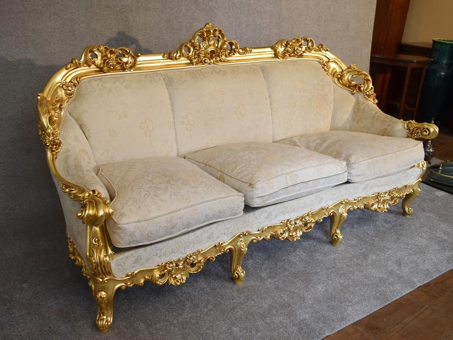 A heavily carved gilt framed Baroque style three cushion sofa with cream fabric and gold coloured - Image 2 of 5
