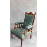 A late 19th century carved oak armchair in Liberty fabric. H.110cm
