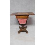 An early Victorian rosewood drop flap sewing table with pull out basket, frieze drawer and chequer