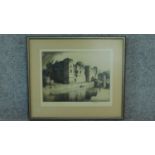 A signed etching by British engraver Stanley Anderson, building by a lake with boats. 51x45cm