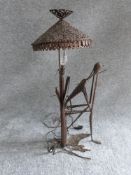 A vintage ironwork seated figure lamp in the style of Giacometti. Pierced conical shade. H 67.5cm