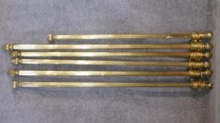 Five miscellaneous brass curtain poles with rings. L.176 (longest)