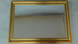 A rectangular gilt framed wall mirror fitted bevelled plate. 76x106cm