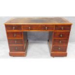A 19th century mahogany three section pedestal desk with an inset tooled leather top and arrangement