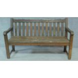 A weathered teak garden bench. H.90 W.148 D.60cm