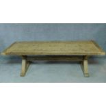 A large pitch pine refectory style dining table with planked top and cleated ends on X-frame
