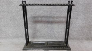 A Victorian style cast iron umbrella stand with twin lift out drip trays. H.64 W.63cm