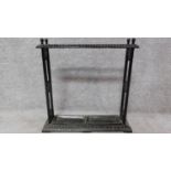 A Victorian style cast iron umbrella stand with twin lift out drip trays. H.64 W.63cm