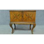 A Continental walnut fitted specimen cabinet with parquetry chequer and starburst inlay. H.56 W.57